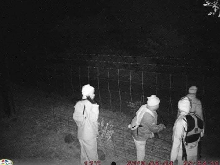 AI detection identifying people at a fence at night